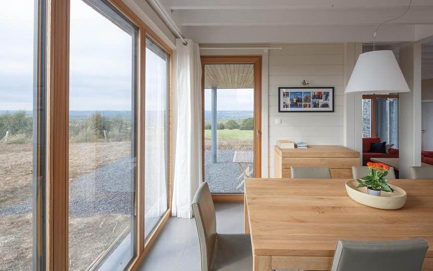 Salle à manger chaleureuse avec fenêtres en mélèze